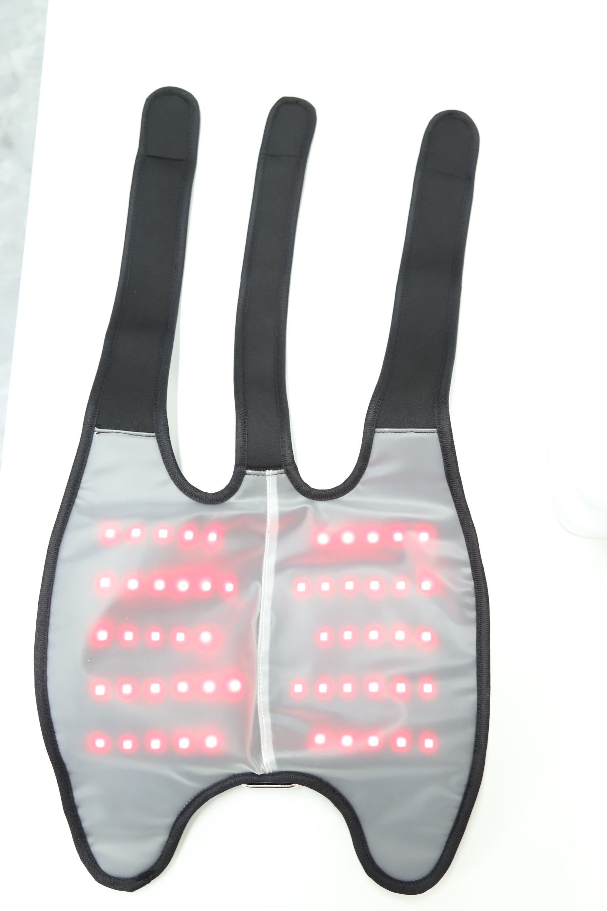 Knee wrap opened flat with the 660nm and 850nm LEDs lit