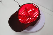 Red light therapy cap with 180 LEDs lit inside the crown
